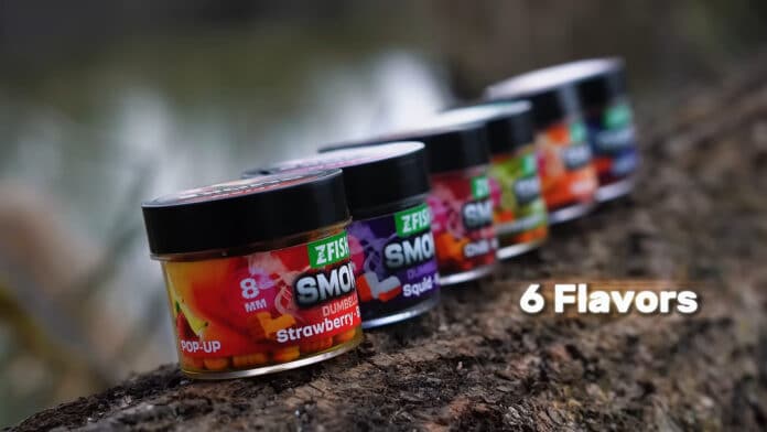 Six colorful jars of Z-Fish bait lined up on a rock, with '6 Flavors' text visible in the corner.