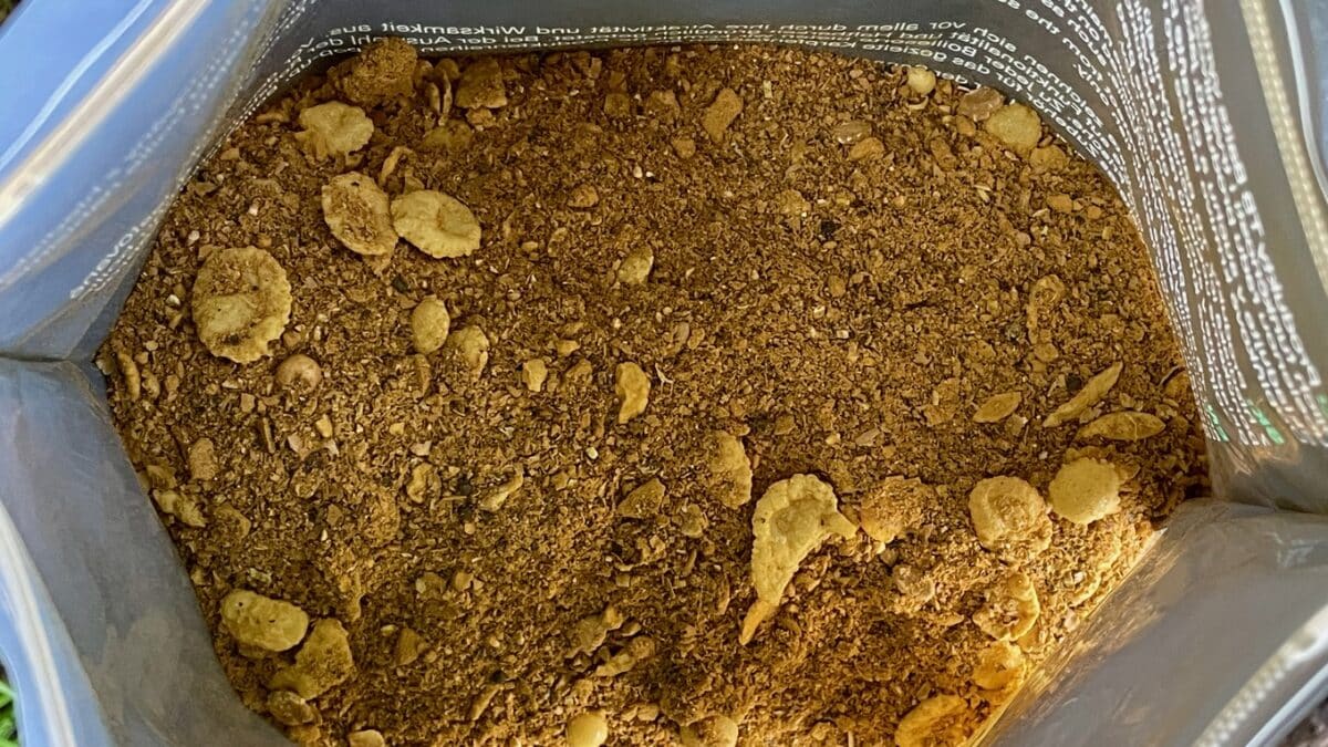 Loose brown soil with small rocks inside an open resealable bag